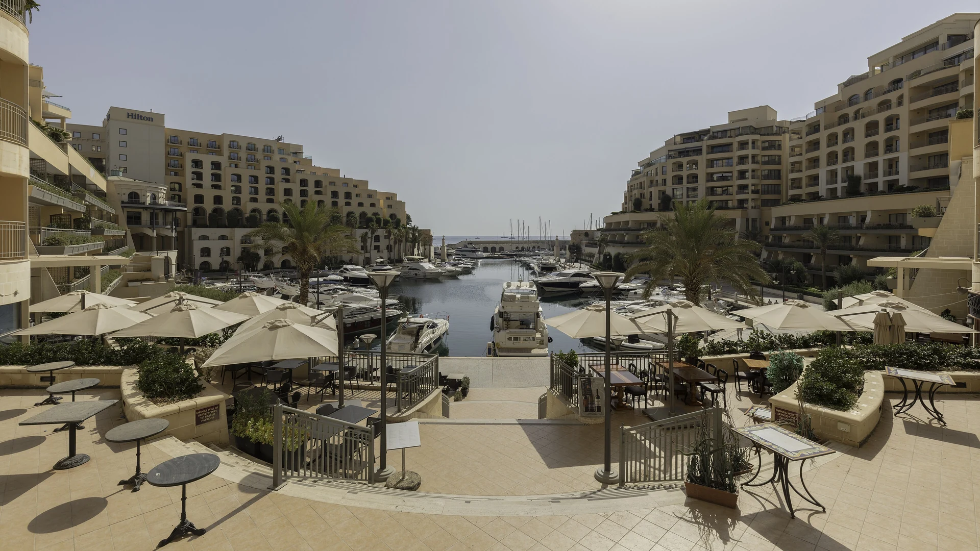 The Portomaso marina in St Julian's, Malta, ringed by hotels and yacht-side restaurant terraces