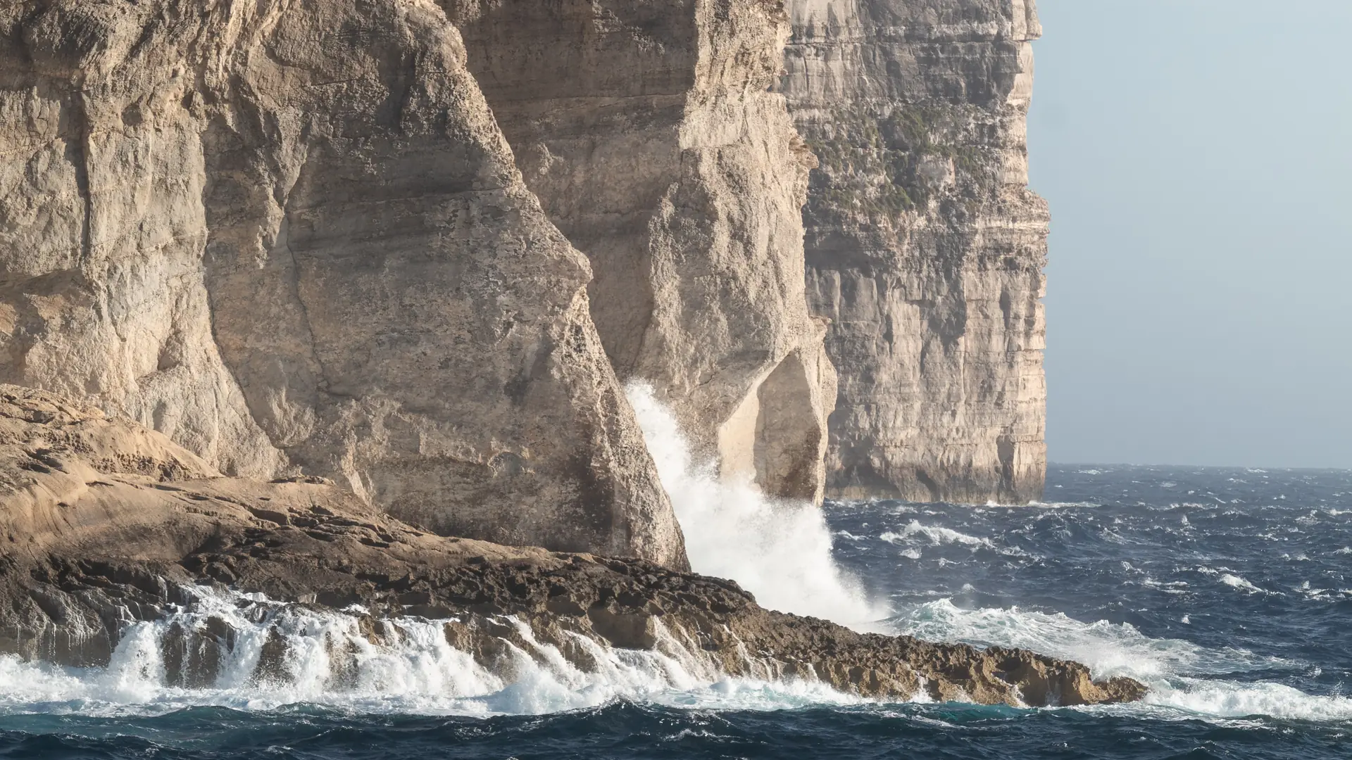 The dramatic rocky coastline at Dwejra, Gozo, with deep blue sea and limestone cliffs – a key stop on quad bike tours