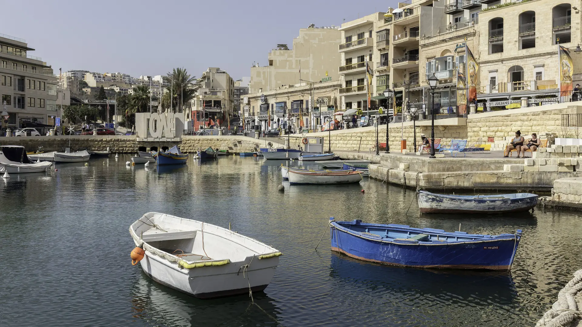 Spinola Bay in St Julian's with traditional boats and waterfront restaurants