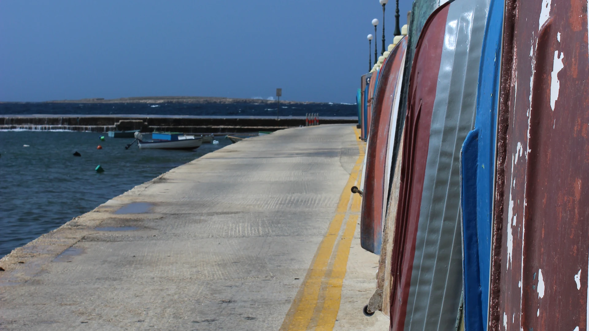 Boats moored at Bugibba Jetty in Malta, the main departure point for Blue Lagoon and Gozo cruises