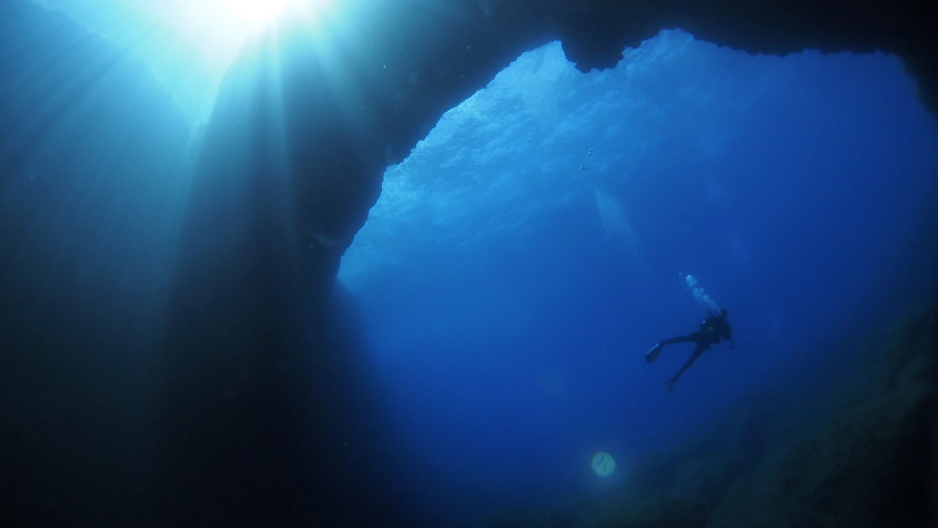 Divers exploring the Blue Hole at Dwejra on the island of Gozo – one of the top dive sites in the Mediterranean