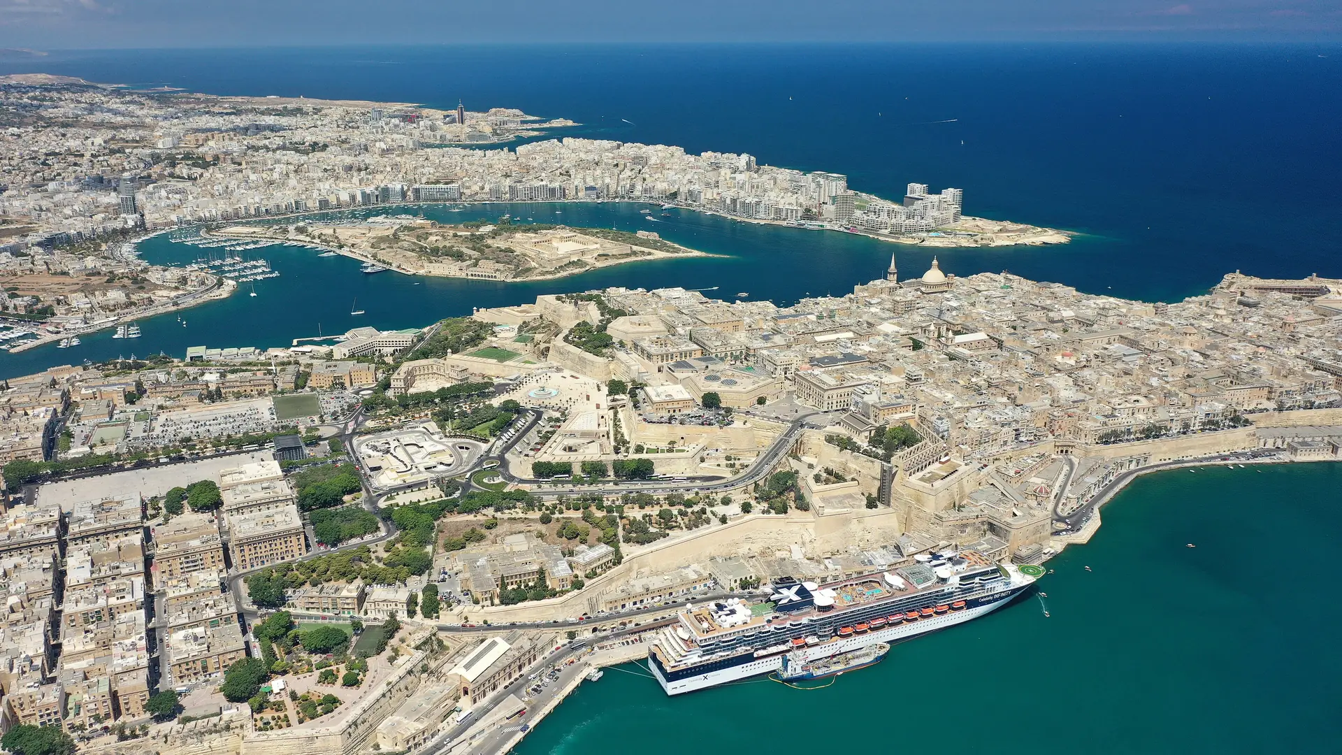 Aerial view of the Valletta peninsula and its harbours under a clear sky, Malta