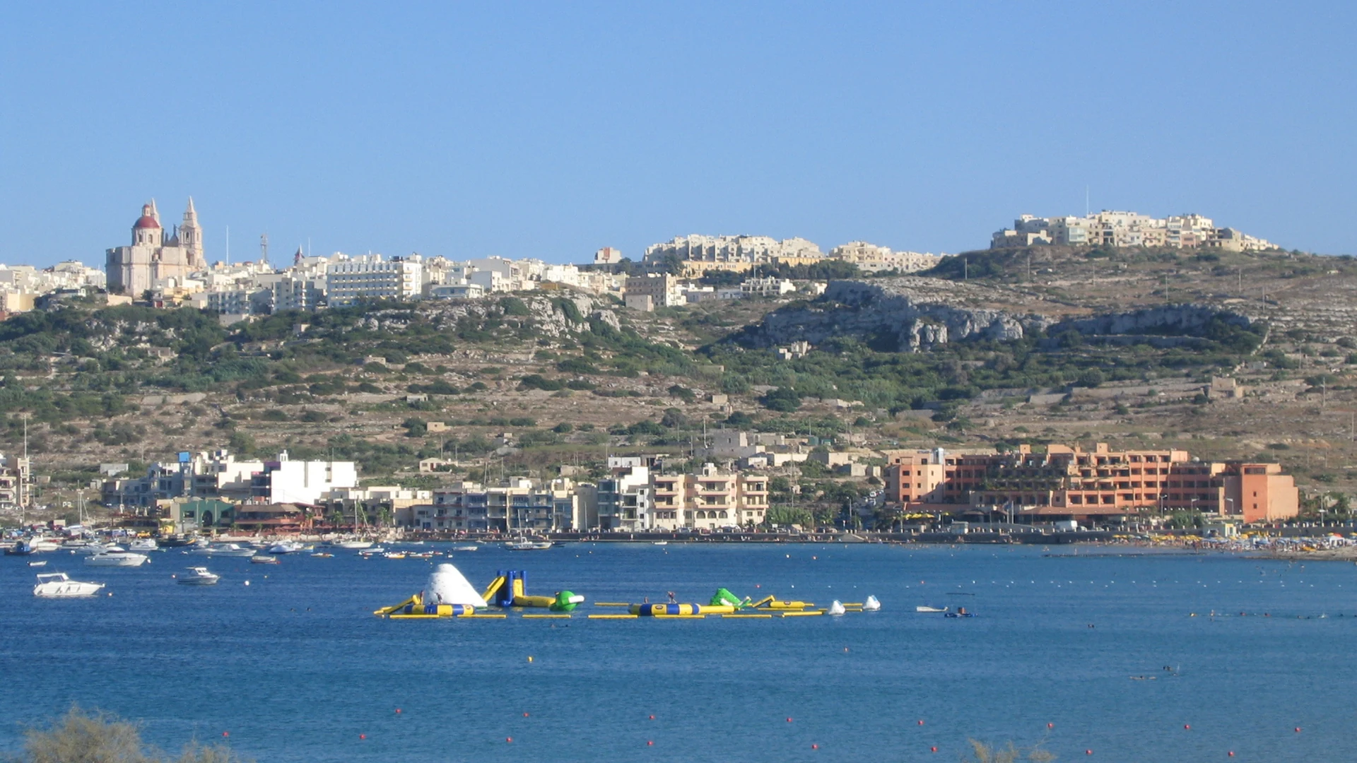 Mellieħa Bay's wide golden sandy beach and turquoise water on Malta's north coast