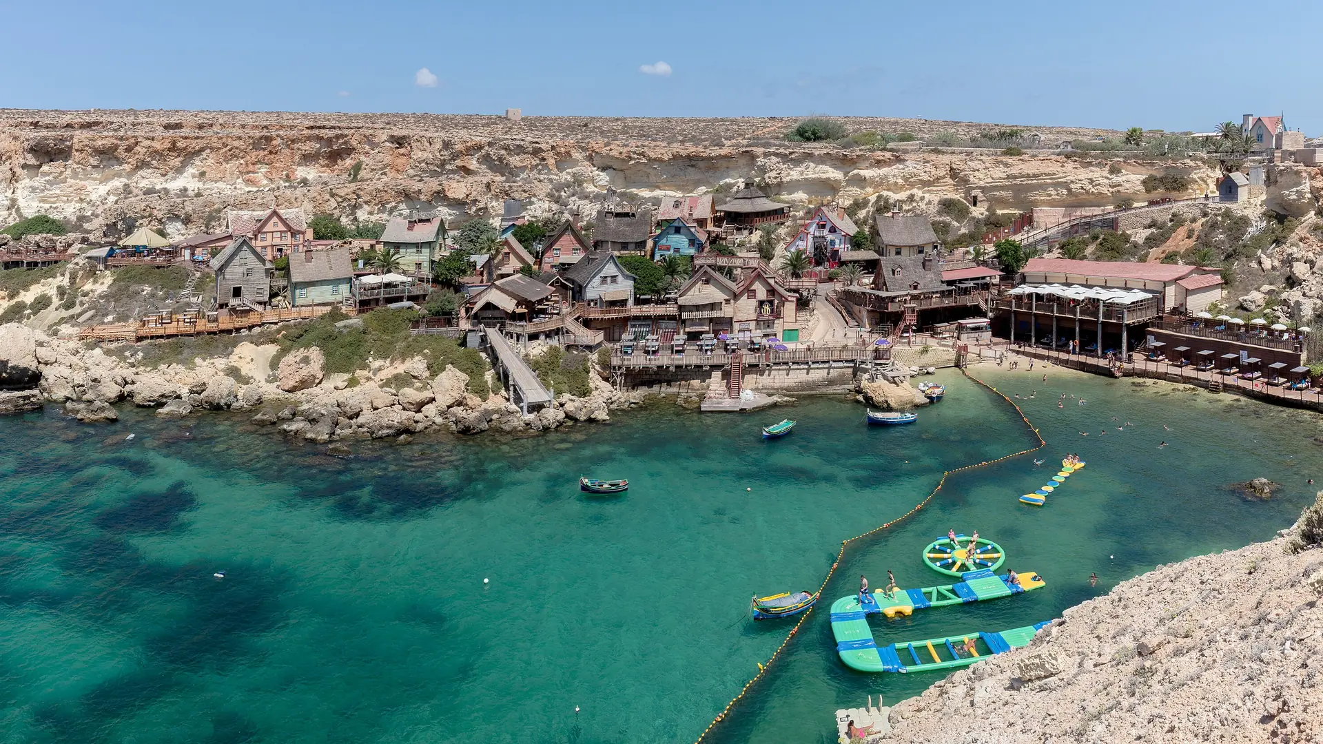 The colourful wooden houses of Popeye Village on Anchor Bay, Mellieħa, Malta