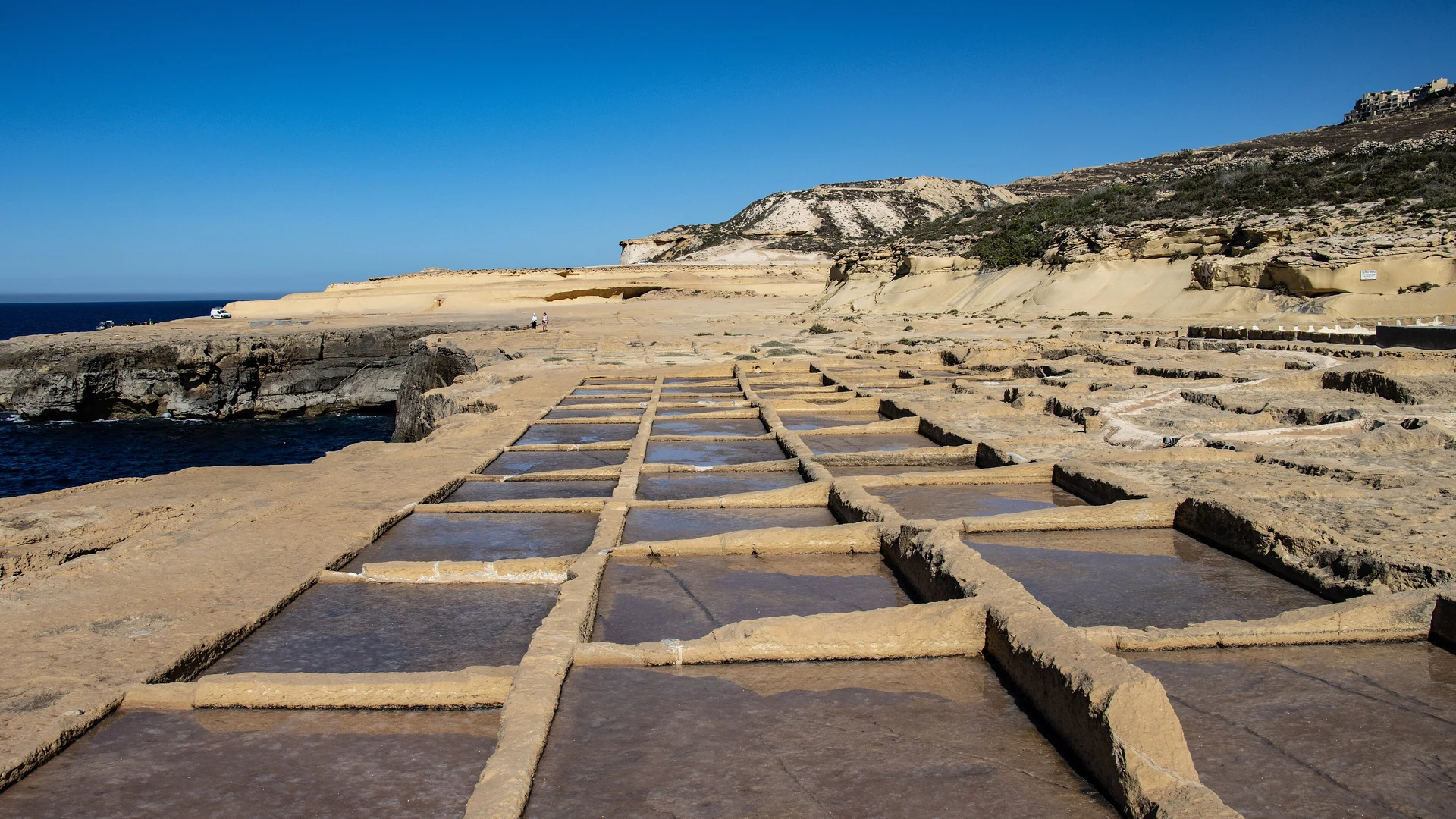 The salt pans on the Gozo coast near Marsalforn, carved into the limestone above the sea